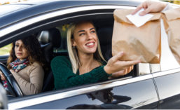Driver receiving food in brown bag