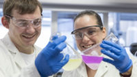 Cargill scientists holding beakers