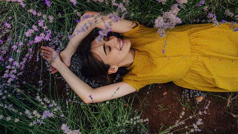 Women Laying Among Flowers 