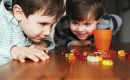 Two Boys Eagerly Looking At Gummy Bears