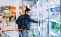 Woman Looking at Refrigerated Beverages