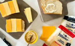 Packages of Tillamook Striped Grilled Cheese, Cheese and Buttered Bread on Serving Boards